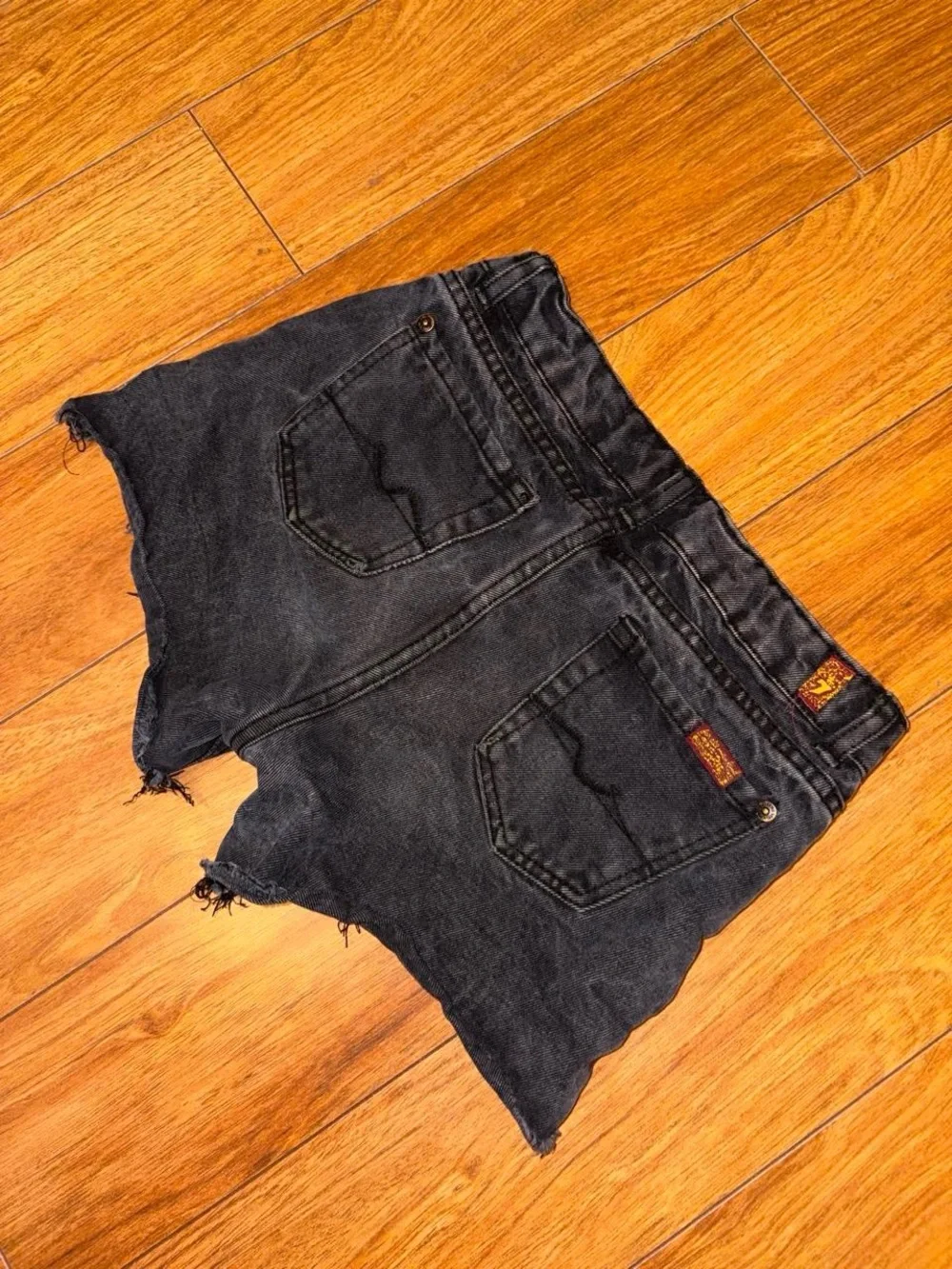 Black denim shorts with a distressed look